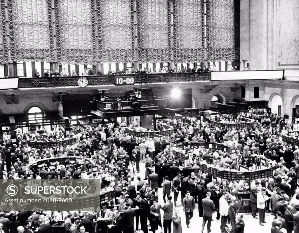 New York Stock Exchange during heavy trading on Oct. 23, 1962. The previous day President John Kennedy announced the presence of offensive missile sites in Cuba. After a half hour of trading, the ticker tape was nine minutes behind transactions.