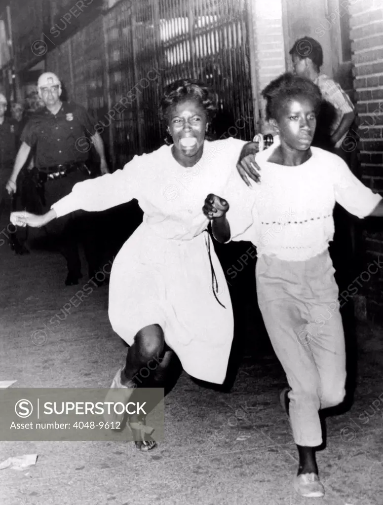 Two young African Americans girls, one screaming during riots in the Bedford-Stuyvesant section of Brooklyn. They were making a dash to freedom as they tried to avoid police. July 21, 1964.