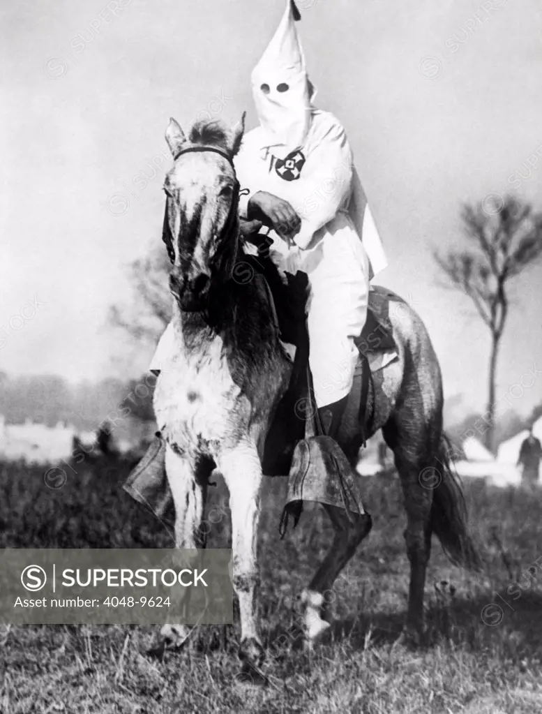 Klansman doing sentry duty near the Klan encampment at Kiles, Ohio. After the Klan targeted the ethically diverse (Irish and Italian) town for an intimidating parade, an anti-Klan organization, the Knights of the Flaming Circle come forward to resist. The result was riot and the arrest of over 100 people. Nov. 1924.