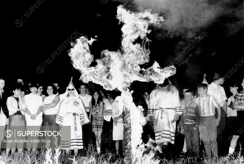 Ku Klux Klan cross burning ceremony, Upper Marlboro, Maryland. Seven members of the group, dressed in their robes, paraded about the cross for than 150 spectators. May 13, 1966.