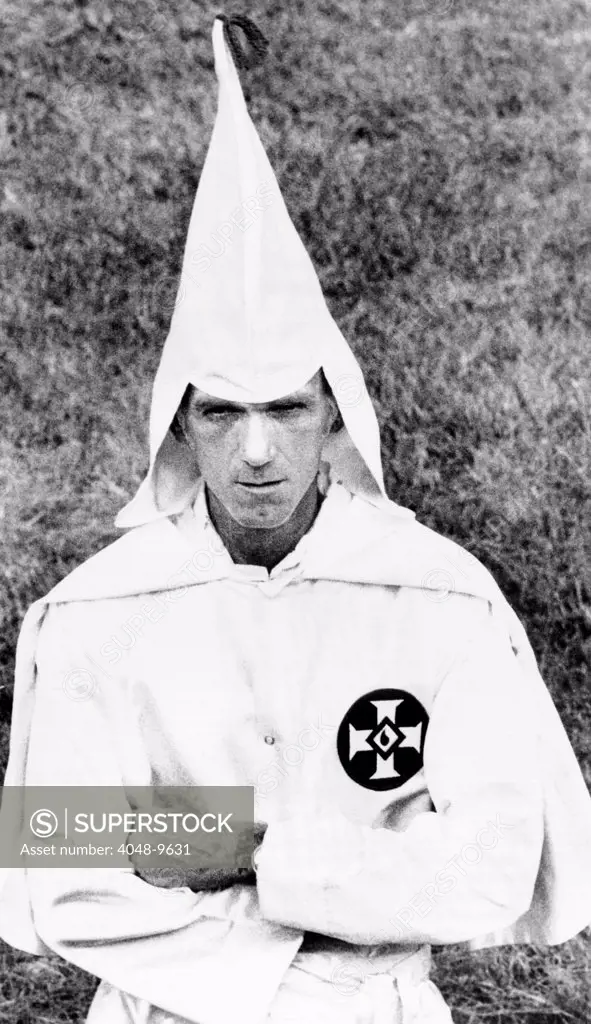 Ku Klux Klansman folds his arms in a traditional Klan posture at a cross burning at a small farm near Indianapolis. July 25, 1975.