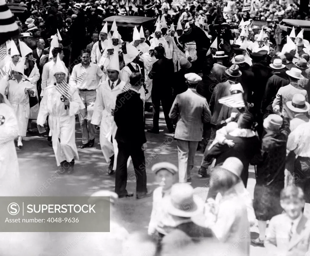 Ku Klux Klan parades in Queens borough of New York City. 1500 Klansmen, including 500 women, battered their way through 110 policemen into the Queen's Memorial Day Parade. Jun. 22, 1927.
