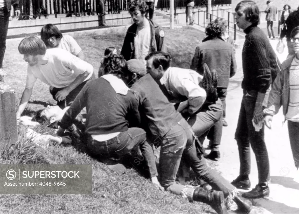 Kent State University students come to the aid of a wounded youth. He was one of 4 students killed and 9 wounded when National Guardsmen fired 67 rounds in 13 seconds into a crowd of 500 Anti-Vietnam War protesters. May 4, 1970.