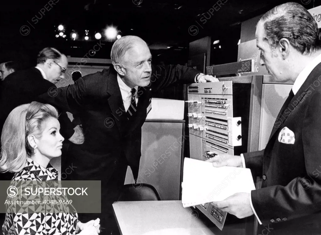 Thomas J. Watson, Jr., talks with IBM stockholders before their yearly meeting in the New York Coliseum. The IBM system/360 40 model was on display. April 24, 1967.