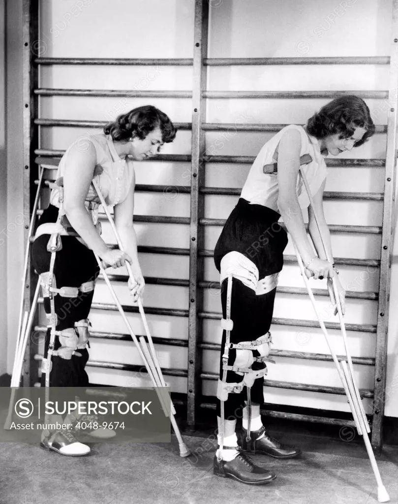 Two adult women polio victims with leg braces adjust their crutches. They are at the New York Institute of Physical Medicine and Rehabilitation where they are undergoing a six month training program. Aug. 7, 1954.