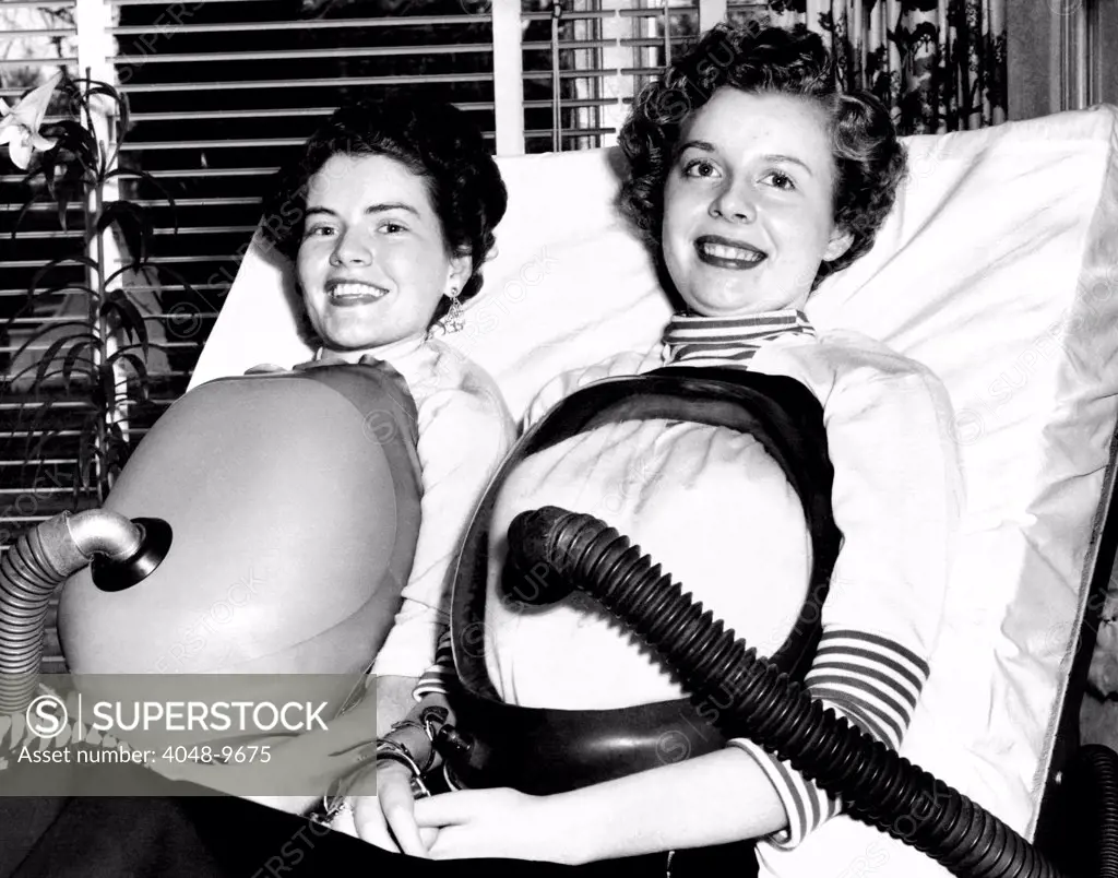 Two women polio victims using chest respirators that free them from the iron lung. Both were stricken in 1953. July 16, 1955.