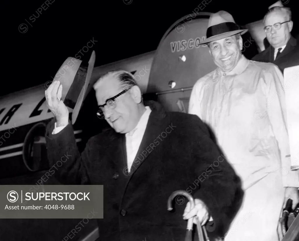 Chicago Police Lt. Anthony DeGrazio deplanes with a cheerful Tory Accardo, leader of the Chicago crime syndicate. DeGrazio was suspended from Chicago police force for accompanying Accardo on the European tour. Nov. 21, 1959.