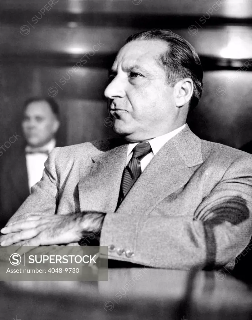 Mob boss, Frank Costello, refusing to testify to the Senate Crime Investigating Committee. He claimed he did not feel well enough to testify and now faces both arrest and a Senate contempt citation. March 15, 1951.