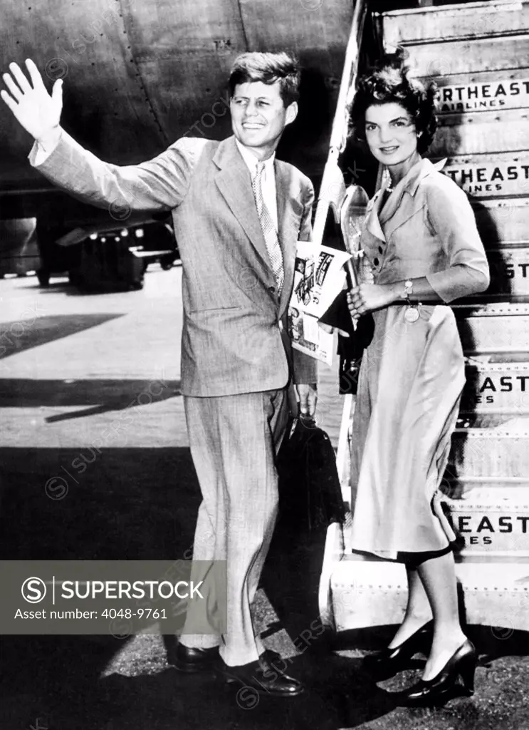 Sen. John Kennedy, waves as he and his fiancée, Washington newspaperwoman, Jacqueline Bouvier, leave LaGuardia Airport weekend of sailing in Hyannis, Mass. June 26, 1953.