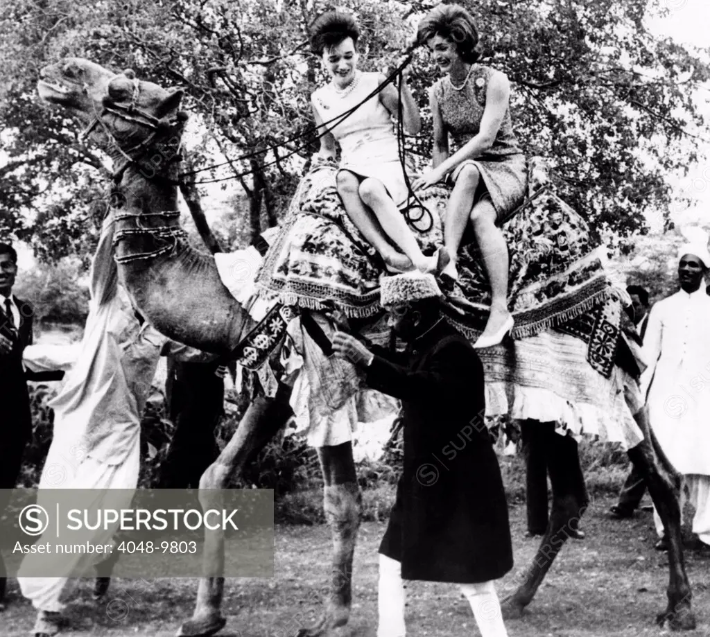 Jacqueline Kennedy and her sister, Princess Lee Radziwill riding a camel. The First Lady was on a good will trip to Pakistan. March 25, 1962.