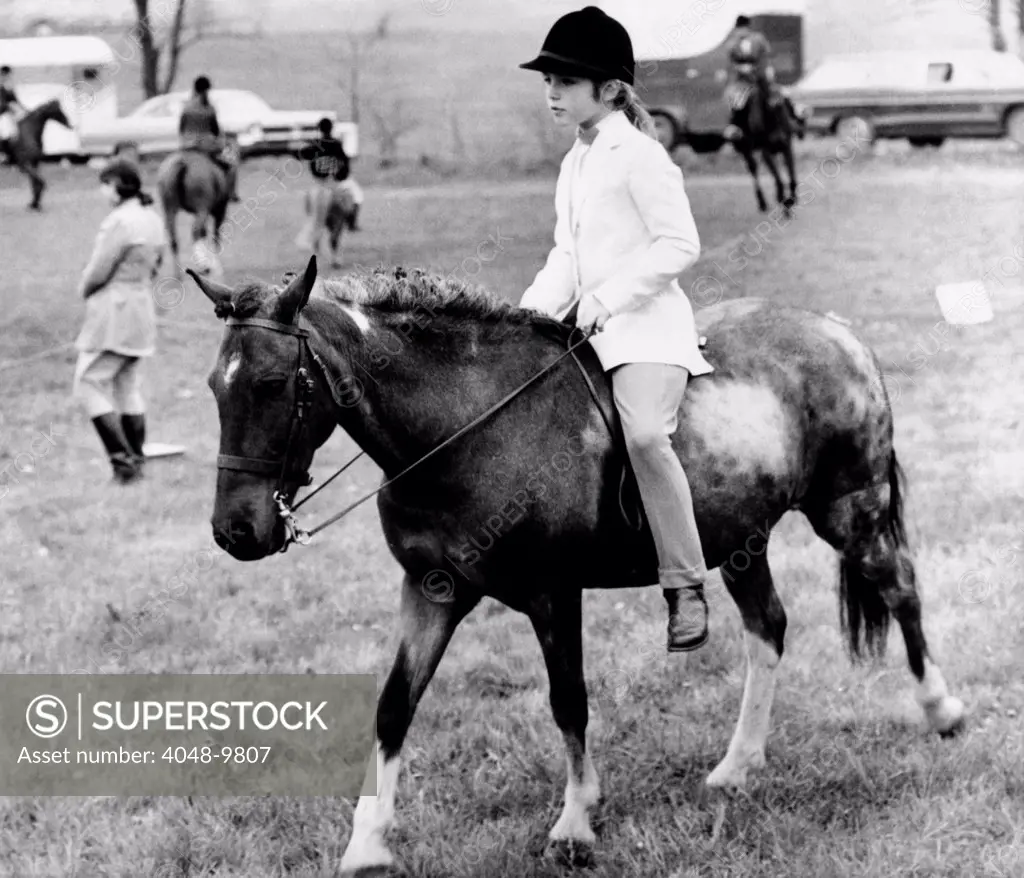 Caroline Kennedy, nine years old, rides her pony Macaroni, at the annual St. Bernard's Horse Show. Gladstone, New Jersey. May 16, 1966.