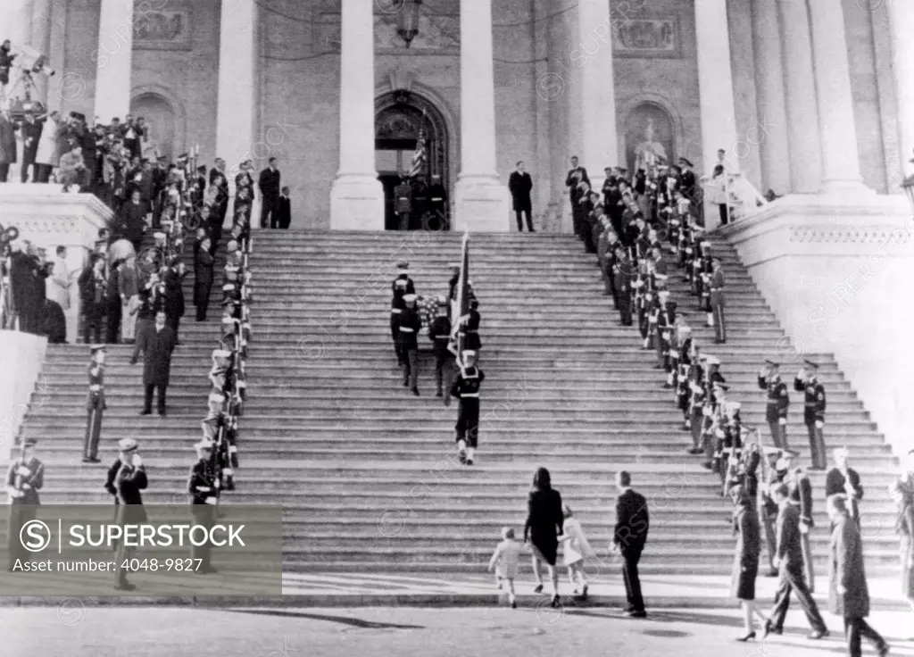 Jacqueline Kennedy escorts her children, Caroline and John, Jr. up the steps of the Capitol. They are following the casket of assassinated President John Kennedy. Other members of the Kennedy family, led by Robert Kennedy are behind. Nov. 24, 1963.