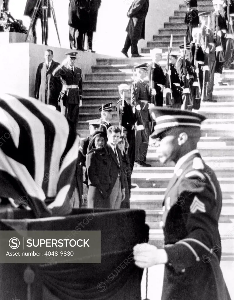 Jacqueline Kennedy, in a widow's veil, watches as coffin containing the body President John Kennedy, is placed on caisson. The coffin is leaving the Capitol in procession to St. Matthews Cathedral, for a high requiem funeral mass. Nov. 25, 1963.