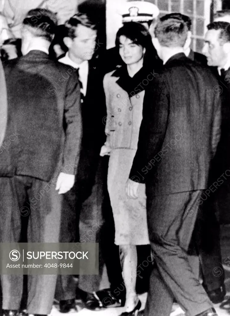 President John Kennedy's body arrives in Washington. Jacqueline Kennedy, still wearing her blood-stained Channel suit, follows as the body of the dead President is placed in an ambulance at Andrews Air Force Base. Beside Mrs. Kennedy is Attorney General Robert Kennedy. Nov. 22, 1963.