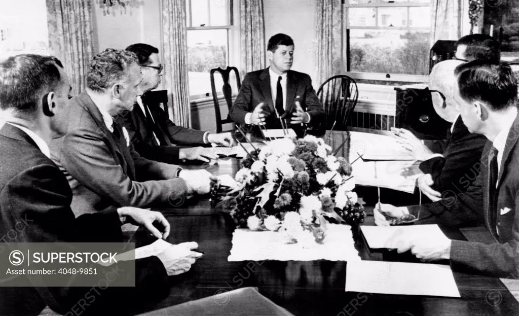 President John Kennedy held a meeting on foreign trade at Hyannis Port. L-R: David Bell, director of the budget, Undersecretary George Ball, Howard Peterson, special assistant to the President for foreign trade matters, the President, Theodore Sorensen, presidential adviser, Secretary of Commerce Luther Hodges, Peter Jones, deputy assistant secretary of Commerce. Nov. 24, 1961.