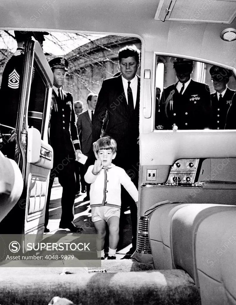 John Kennedy Jr. enters the Presidential Limousine as his father, the President, follows. They were attending Veteran's Day ceremonies at Arlington National Cemetery. Nov. 11, 1963.