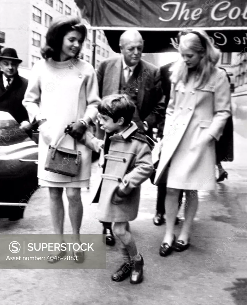 Jacqueline Kennedy, Randolph Churchill, his daughter, Arabella Churchill, and John F. Kennedy Jr. leaving the Colonial Restaurant in New York. Dec. 1966.