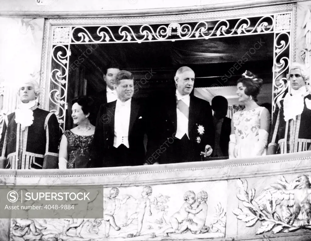 President and Jacqueline Kennedy at the Palace of Versailles. Madame Yvonne de Gaulle, Pres. John Kennedy, Pres. Charles de Gaulle, and Jacqueline Kennedy stand before the playing of the French and American national anthems at the Louis XV Theater. June 1, 1961.