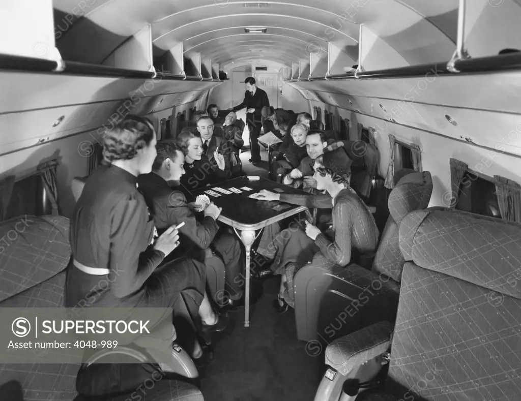 Passengers play cards on United Airline's Skylounge Mainliner, 1937