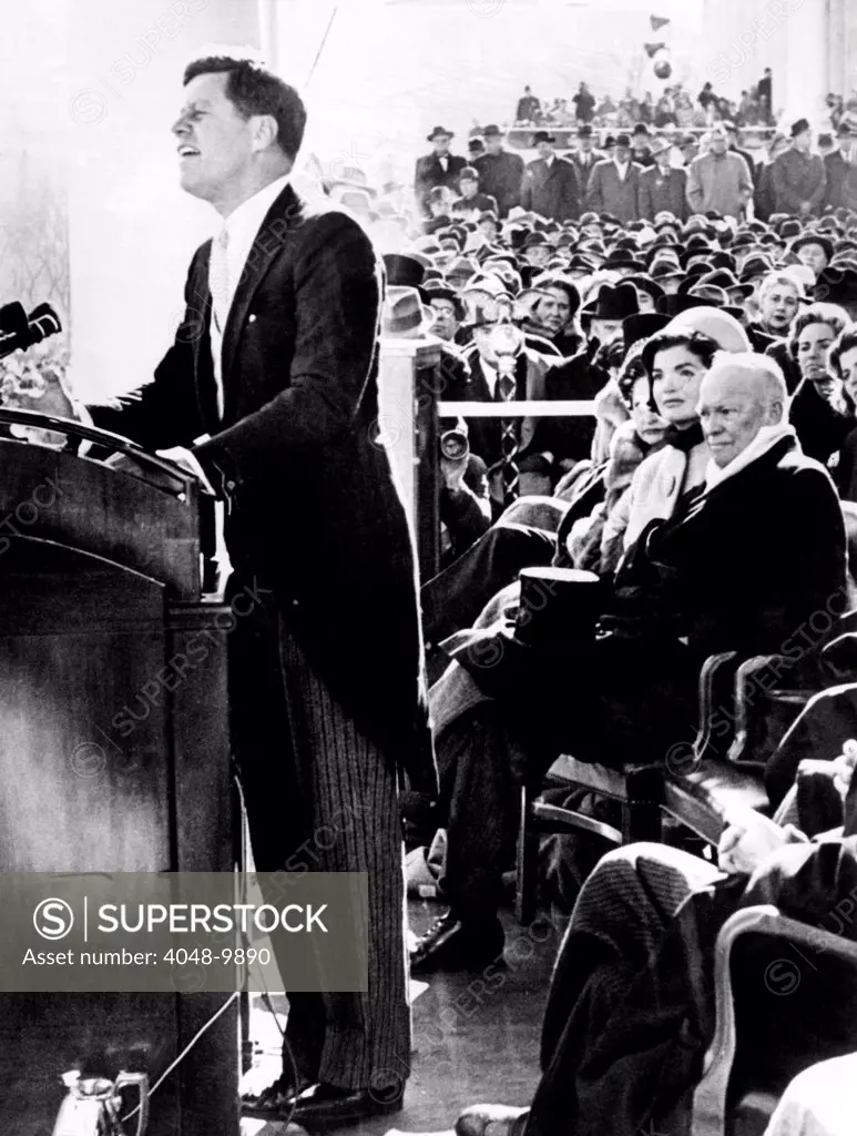 President John Kennedy delivering his inaugural address. Outgoing President Dwight Eisenhower, Jacqueline Kennedy look on. Jan. 20, 1961.