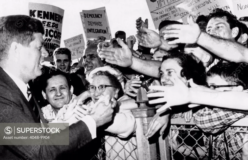 President John Kennedy greets well-wishers. JFK shakes hands at the Bridgeport, Connecticut airport while campaigning for Democratic candidates in the mid-term election. Oct. 17, 1962.