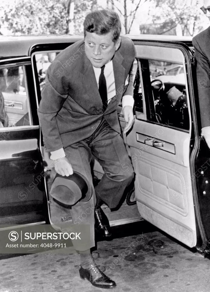 President John Kennedy steps from his limousine during the Cuban Missile Crisis. He was attending mass at St. Stephens church. Later in the day the crisis broke, when Soviet Premier Khrushchev announced that Russia would dismantle the missile bases in Cuba. Oct. 28, 1962.