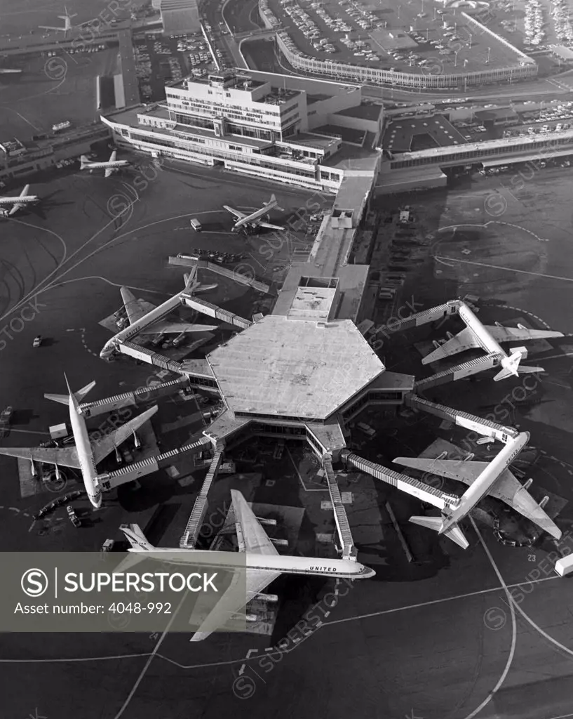 A Super DC-8 airplane (bottom) sits at the United Airlines terminal at the San Francisco International Airport, 1967