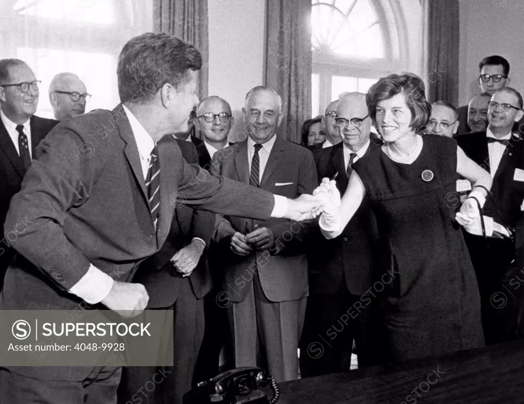 Eunice Shriver receives a signing pen from her brother, President John Kennedy. He called her the No. 1 lobbyist for the $355 million bill he just signed. It would will combat mental retardation through improved maternal and infant care. Oct. 24, 1963.