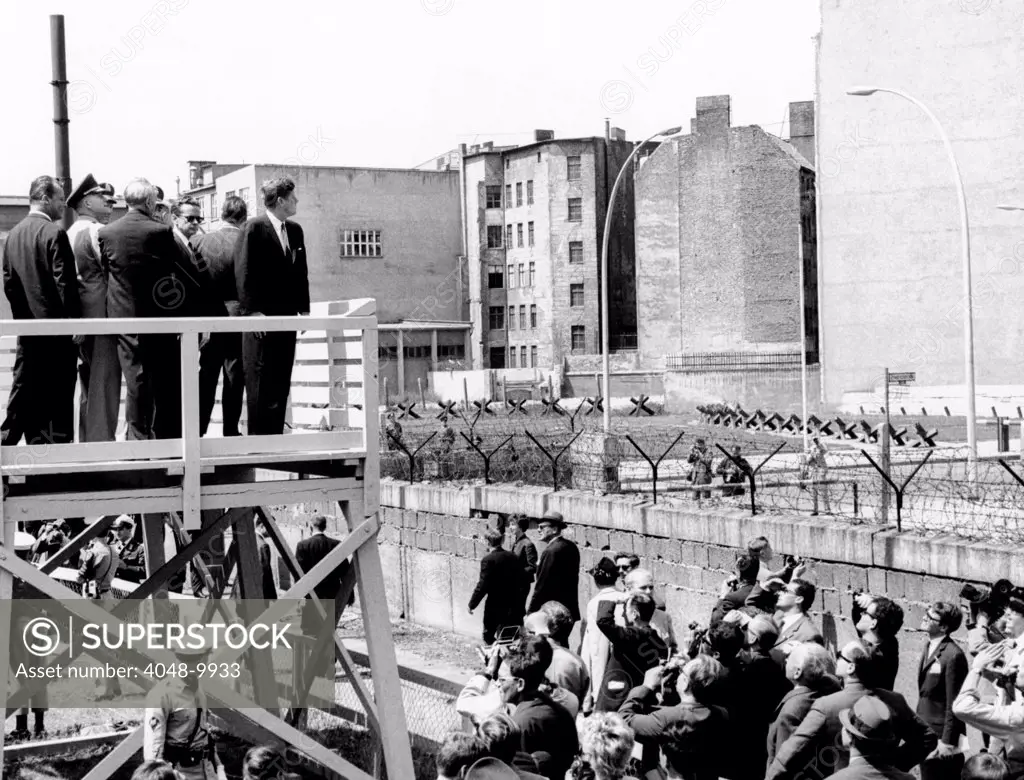 President John Kennedy in Berlin. On a specially erected platform, JFK views the communist wall which separates East and West Berlin. July 26, 1926.