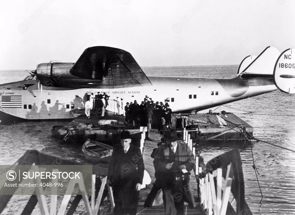 The first passengers to cross the Atlantic leave Pan American's Dixie Clipper airplane in Lisbon, Portugal. The plane took off from Port Washington, New York, 1939