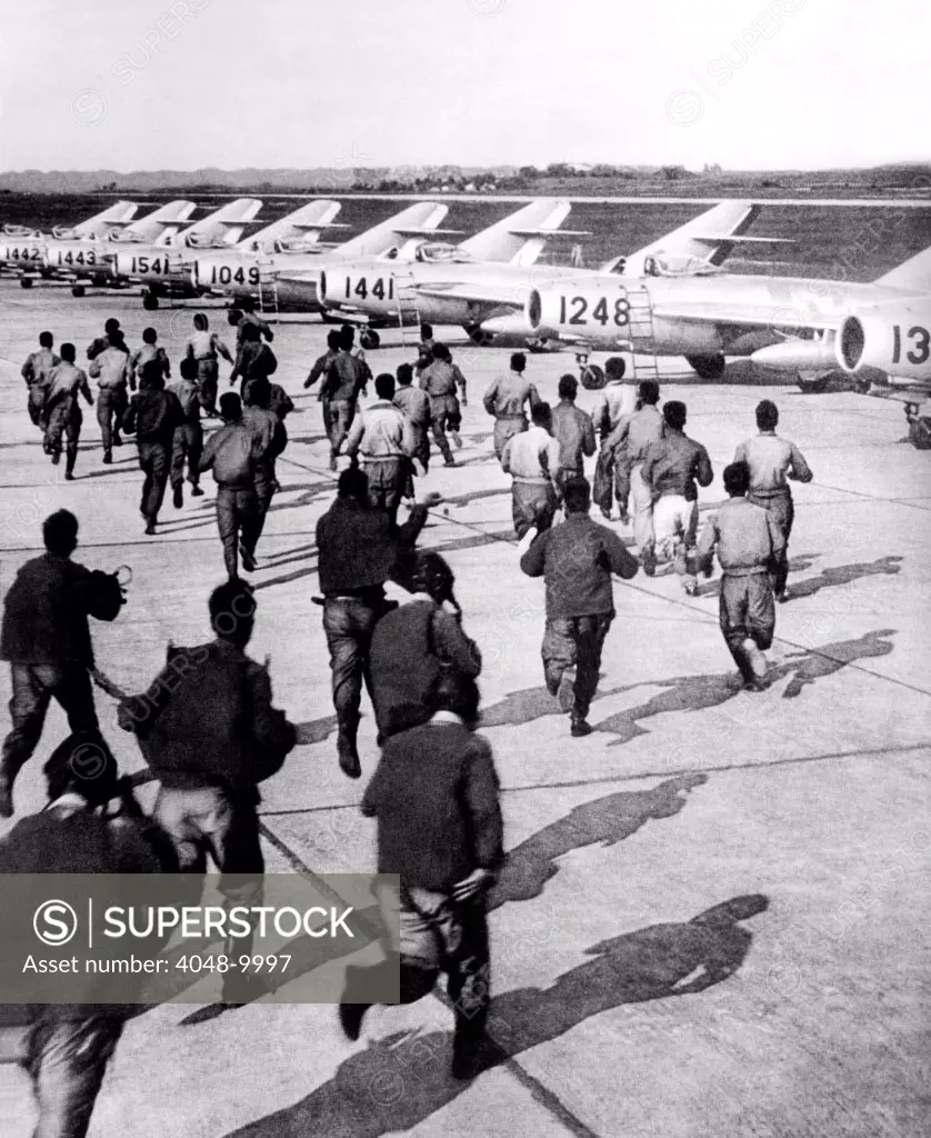 Red Chinese Army Mig Pilots rush to their planes during training at an unidentified air base in Red China. May 13, 1966.