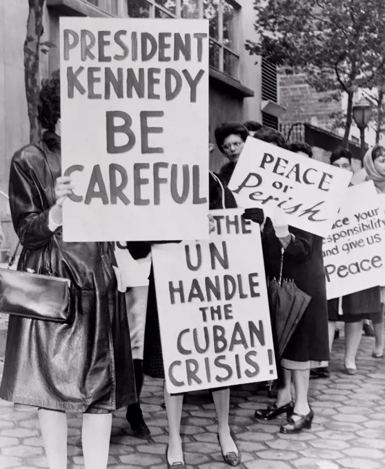 Women Strike for Peace. Some of the 800 women demonstrators holding placards reading 'President Kennedy Be Careful' and 'Let the UN handle the Cuban Crisis'. October 1962.