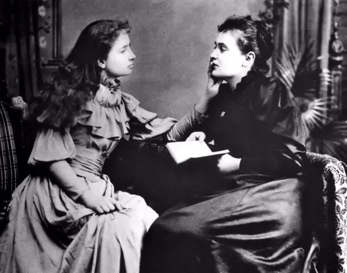 Photo illustrates how Helen Keller (left) 'hears' her instructor, Anne Sullivan by feeling the vibrations of her lips.
