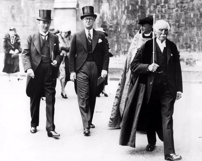 WINCHESTER, ENG: Joseph P. Kennedy (center), U.S. Ambassador to Britain, walking with Lord Mottistone (left), Lord Lieutenant of Hampshire, and the Very Rev. Dr. E.G. Selwyn (right, partly obscured) Dean of Winchester, 7/18/38.