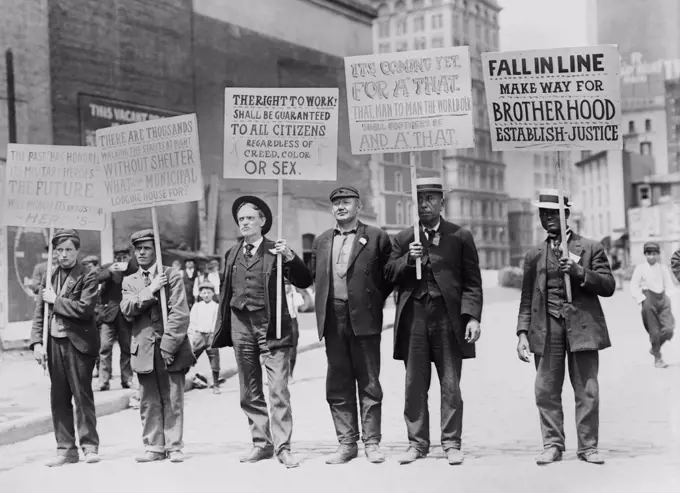 Parade of unemployed men, carrying signs, New York City, May 1909. One sign asks, 'There Are Thousands Walking the Streets at Night without Shelter. What is the Municiple Lodging House For' An African American man's sign reads, 'Fall in Line. Make Way for Brotherhood. Establish Justice.'  (BSLOC_2018_1_139)