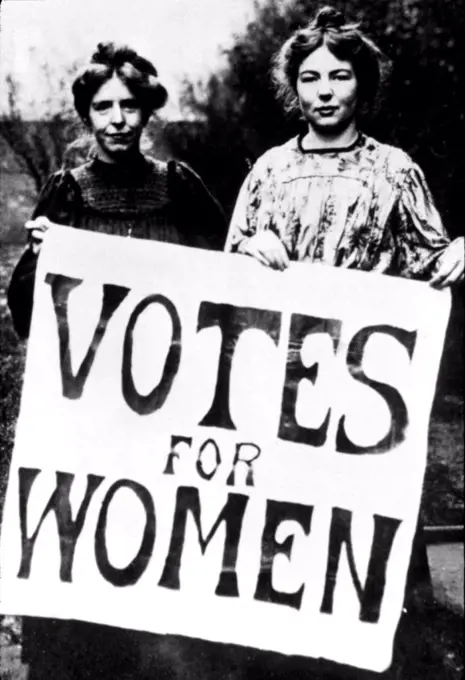 Suffragettes at turn of the last century holding Votes for Women picket sign, U.S., 1910s.