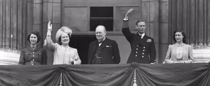 British Royal Family waves to crowds on Victory in Europe Day, May 8, 1945. Prime Minister Winston Churchill takes the central position of honor on the Buckingham Palace balcony. L to R: Princess Elizabeth, wear her ATS Uniform; Queen Elizabeth, Winston Churchill, King George and Princess Margaret. - (BSLOC_2014_14_19)