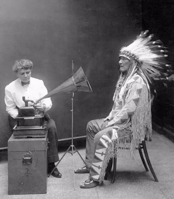 Native American having his voice recorded. Original caption reads: 'Piegan Indian, Mountain Chief, having his voice recorded by ethnologist Frances Densmore', 1916.