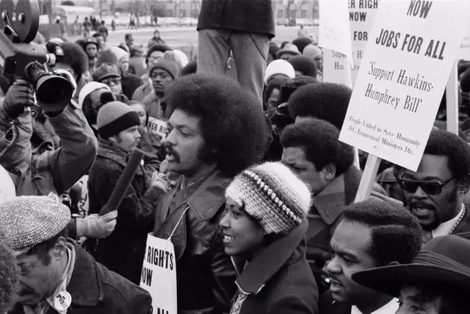 Reverend Jesse Jackson (center, second row), leads a march for jobs around the White House, protesters carry signs advocating support for the Hawkins-Humphrey Bill for employment, Washington DC, photograph by Thomas J. O'Halloran, January 15, 1975.