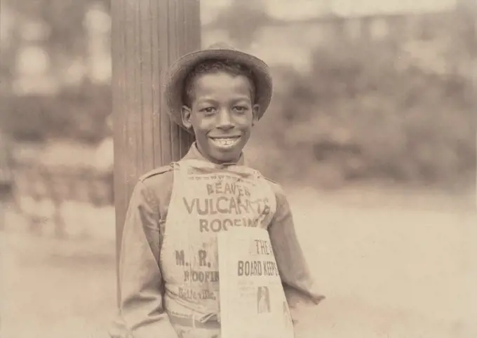 African American newsie, original caption: 'Roland, eleven year old negro newsboy', Newark, New Jersey, photograph by Lewis Wickes Hine, August 1, 1924.