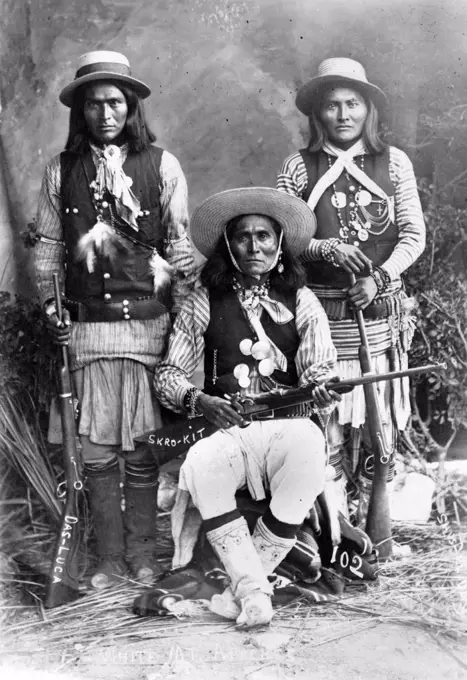 Wild West. Das-Luca, Skro-Kit, Shus-El-Day: White Mountain Apaches posed with rifles, 1909