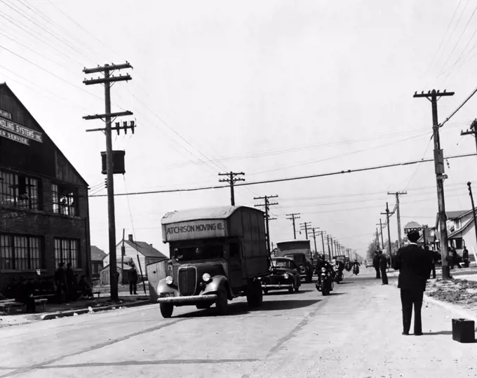 Integration. A convoy of African-American moving trucks protected by police cars. Whites had protested integration of the Sojourner Truth homes, a new U.S. federal housing project. Detroit, Michigan,  Arthur Siegel photograph, 1942