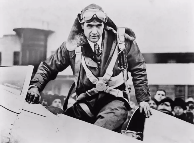 Howard Hughes emerging from an airplane cockpit on his arrival at Newark Airport 7 hours and 28 minutes after leaving from Los Angeles. Hughes averaged a record-breaking speed of 332 miles per hour over the 2 490 mile flight. January 19 1937. LC-USZ62-124392
