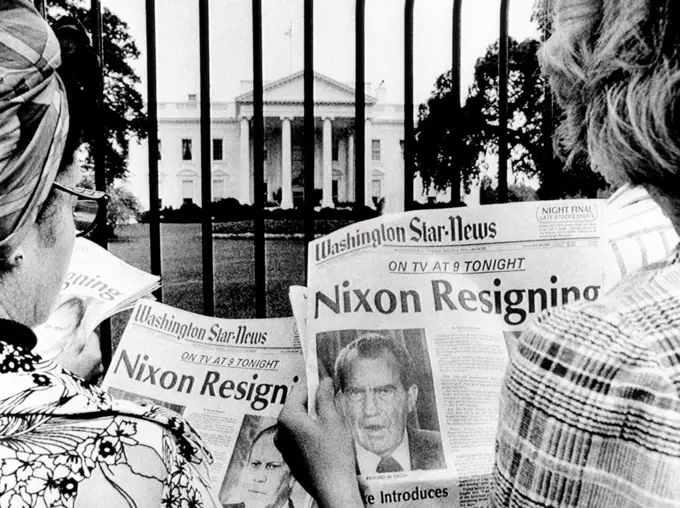 Tourists in front of the White House read headlines, 'Nixon Resigning.' Aug. 8, 1974.