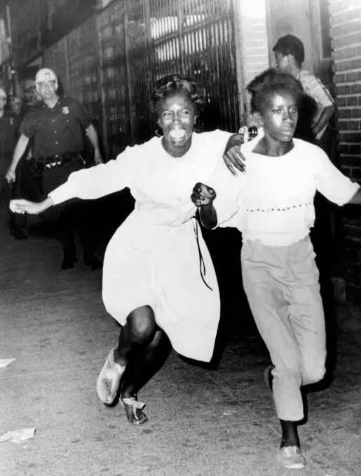 Two young African Americans girls, one screaming during riots in the Bedford-Stuyvesant section of Brooklyn. They were making a dash to freedom as they tried to avoid police. July 21, 1964.