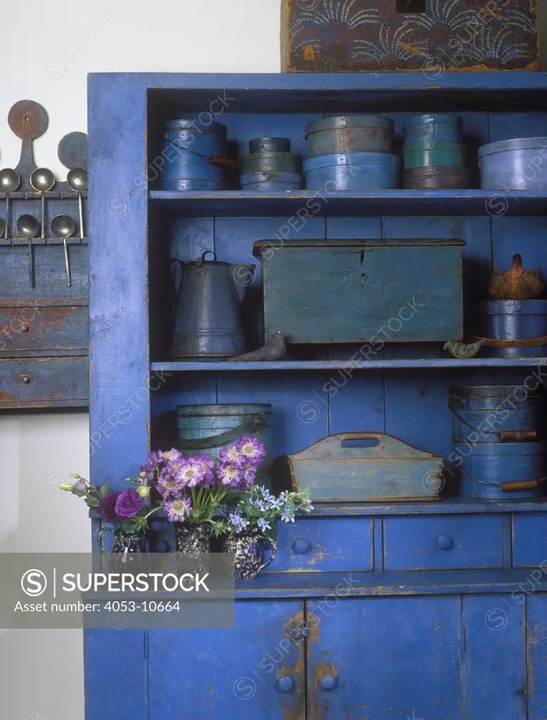 COLLECTION DISPLAYS - American blue primitive weathered cupboard, blue and teal firkins,  Shaker and pantry boxes. Purple and violet flowers detail still life shot