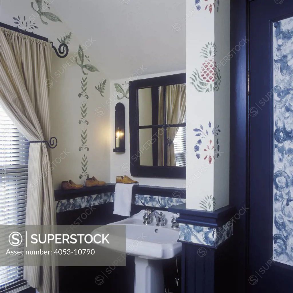 BATHROOMS: Pedestal sink in bath open to bedroom mirror frame was once a window, wall stenciling.