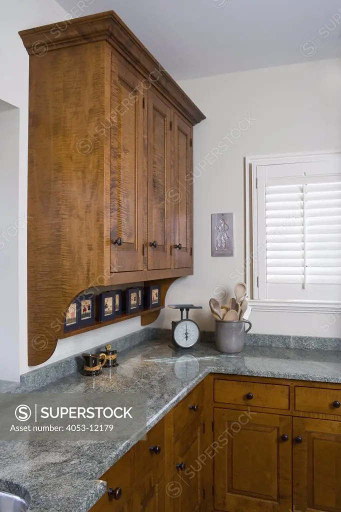 KITCHEN: Modern country style with clean lined furniture style cabinets, in green and warm maple stain, corner cabinet, green granite counters, small window with  shutters