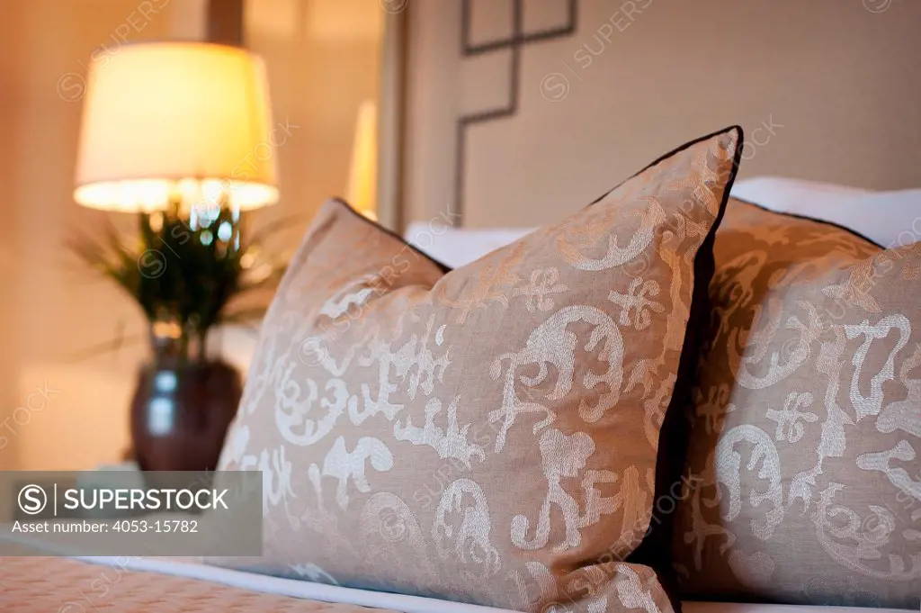 Close-up of pillows arranged on bed with large beige headboard at home, Scottsdale, USA. Arizona, USA. 01/25/2013