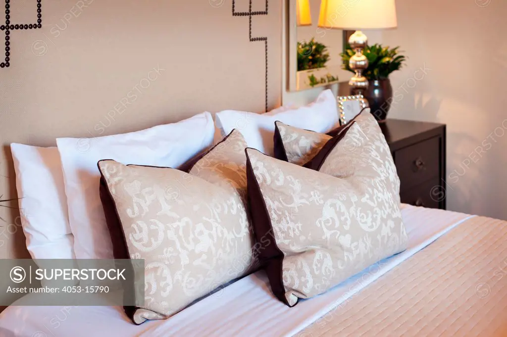 Close-up of pillows arranged on bed with large beige headboard at home, Scottsdale, USA. Arizona, USA. 01/25/2013